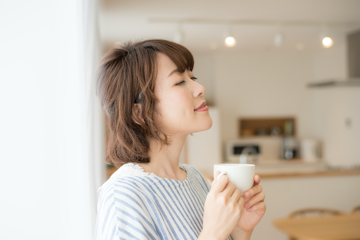 カップを持ってくつろぐ女性